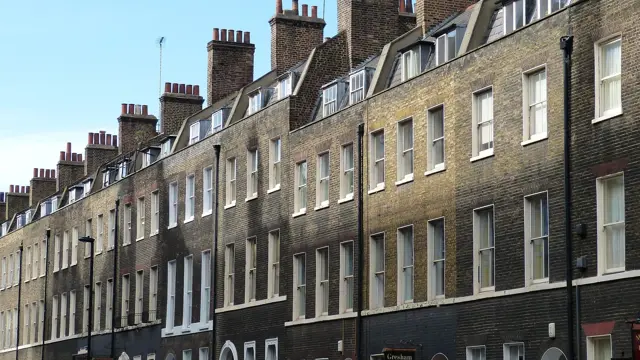 Row Of UK Terraced Homes Representing Social Housing And Housing Services