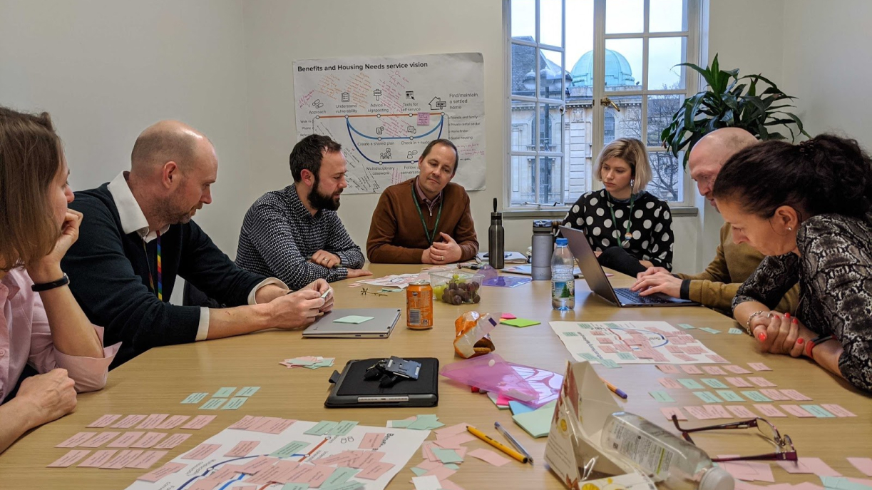 People sat around a table in discussion
